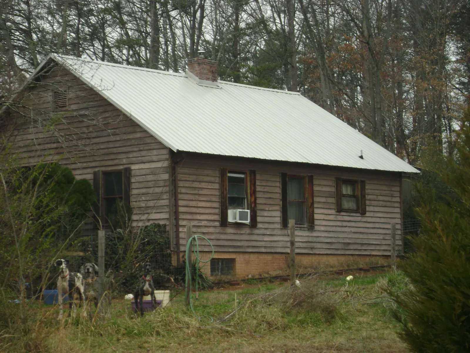 White metal roof on an old wood sided farmhouse, from a Metal Roof Installation job in North Weymouth