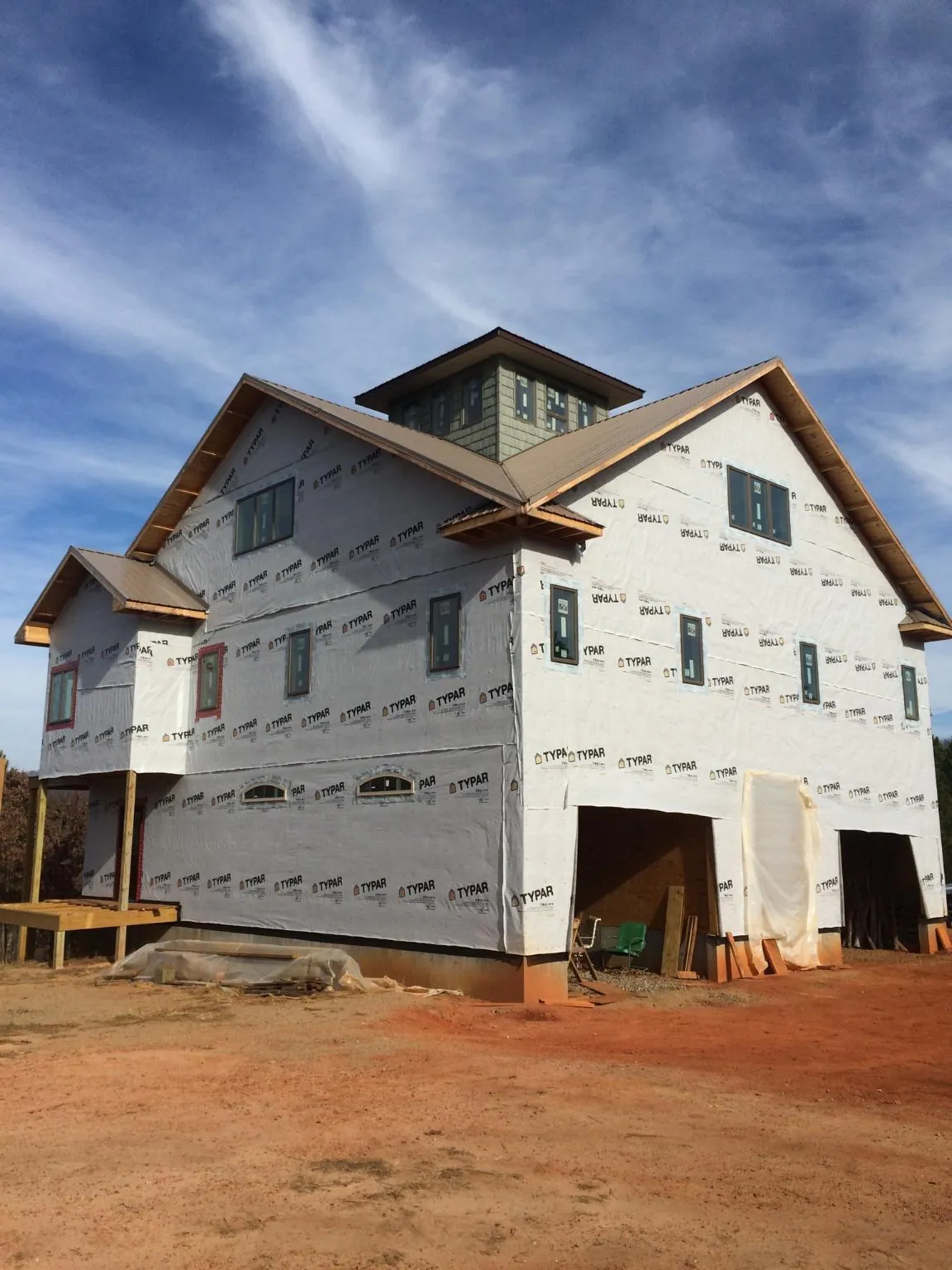 New two story house under construction with a cupola and gabled roofs in North Weymouth